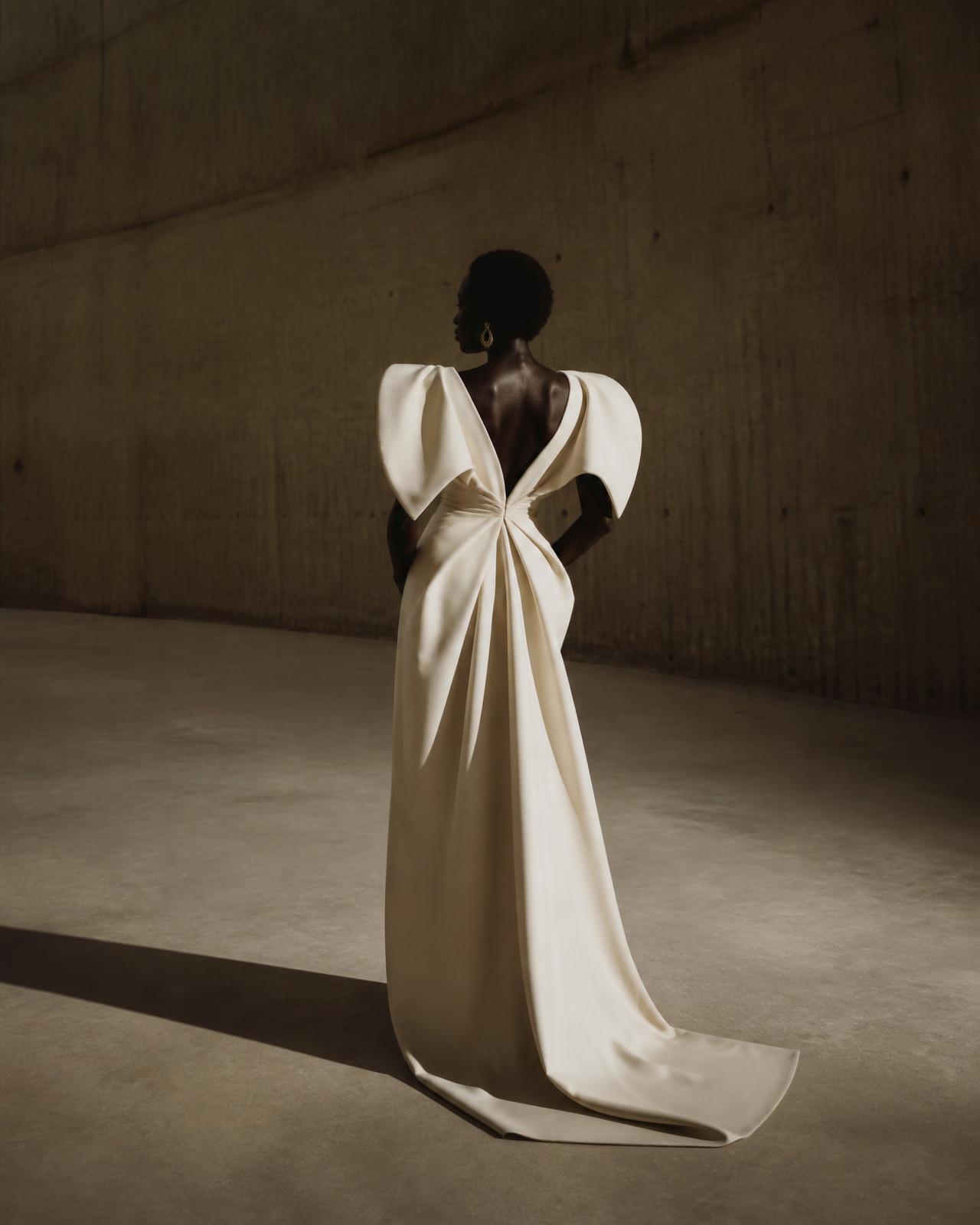 Ivory MOKO gown with architectural sleeves and flowing train